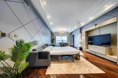 a living room with a bed and a tv at Nice 2BD apartment in the Palm Jumeirah in Dubai