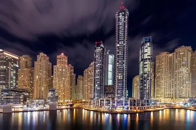 a night view of a large city with tall buildings at Crowne Plaza Dubai Marina by IHG in Dubai