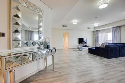 a living room with a large mirror and a couch at Harmony Vacation Homes - BALQIS Residence in Dubai