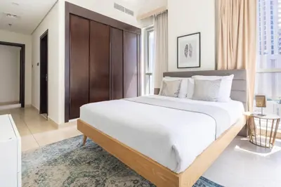 a bedroom with a large bed with white sheets at Frank Porter - Mon Reve in Dubai