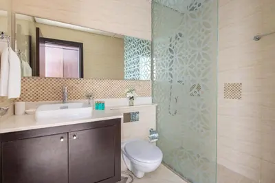 a bathroom with a toilet and a sink and a shower at Frank Porter - Mon Reve in Dubai