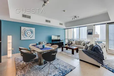 a living room with a couch and a table at Al Majara by EMAAR, Dubai Marina in Dubai
