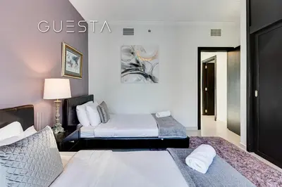 a bedroom with two beds in a room at Al Majara by EMAAR, Dubai Marina in Dubai