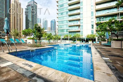 a swimming pool in the middle of a city with tall buildings at Al Majara by EMAAR, Dubai Marina in Dubai