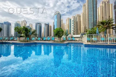 a large swimming pool in front of a city at Al Majara by EMAAR, Dubai Marina in Dubai