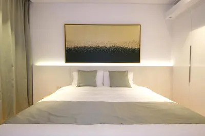 a bedroom with a bed with a painting above it at New Arabian Luxury 2 Bedroom In Blue Water in Dubai