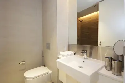 a bathroom with a sink and a toilet and a mirror at New Arabian Luxury 2 Bedroom In Blue Water in Dubai