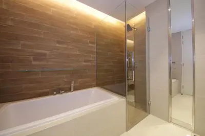 a bathroom with a tub and a glass shower at New Arabian Luxury 2 Bedroom In Blue Water in Dubai