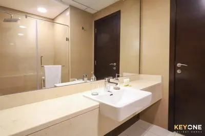 a bathroom with a sink and a large mirror at Sophisticated One Bedroom with Full Marina View in Dubai