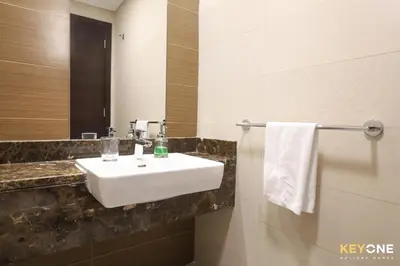 a bathroom with a sink and a mirror at Sophisticated One Bedroom with Full Marina View in Dubai