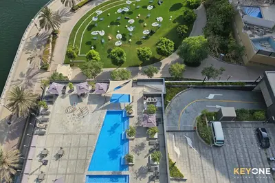 an overhead view of a resort with a swimming pool at Sophisticated One Bedroom with Full Marina View in Dubai