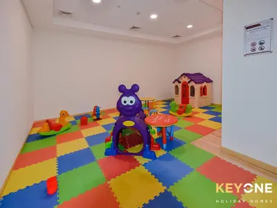 a childs room with a play area with a toy at Sophisticated One Bedroom with Full Marina View in Dubai