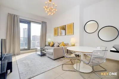 a living room with a couch and a table at Sophisticated One Bedroom with Full Marina View in Dubai