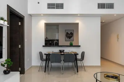 a kitchen and dining room with a table and chairs at Silverene Towers Dubai Marina - By Home Of Choice in Dubai