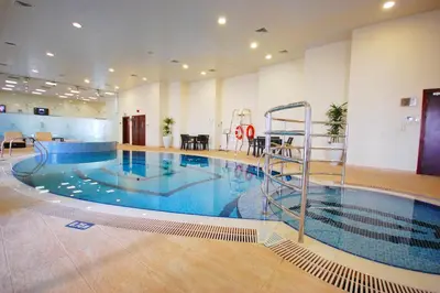 a large swimming pool in a large building at Princess Tower highest world Penthouse floor 86! in Dubai