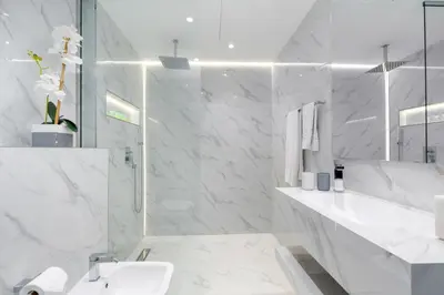 a white bathroom with a sink and a mirror at Princess Tower highest world Penthouse floor 86! in Dubai