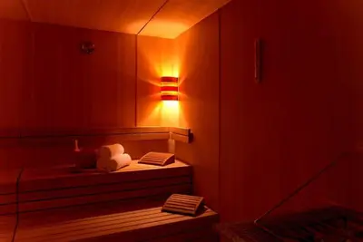a room with a bed with a light on the wall at HotelApart Dubai Mall st Burj Khalifa View in Dubai