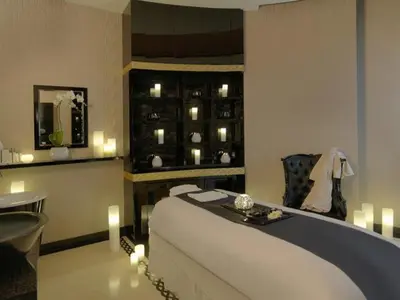 a bedroom with a bed and a table and candles at HotelApart Dubai Mall st Burj Khalifa View in Dubai