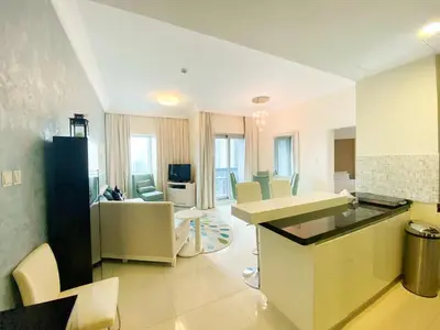 a kitchen and living room with a table and chairs at HotelApart Dubai Mall st Burj Khalifa View in Dubai