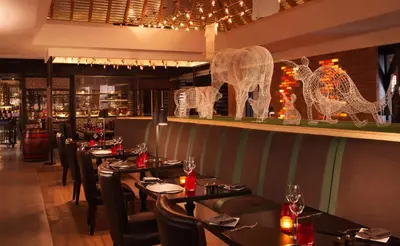a restaurant with tables and chairs and decorations on the wall at Anantara The Palm Dubai Resort in Dubai