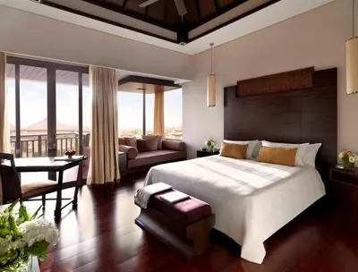 a bedroom with a large bed and a living room at Anantara The Palm Dubai Resort in Dubai