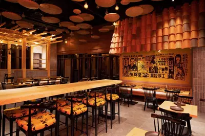 a restaurant with a long bar and chairs in it at Citymax Hotel Business Bay in Dubai