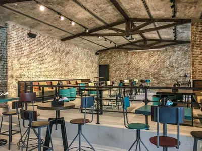 a room with tables and chairs and a brick wall at Citymax Hotel Business Bay in Dubai