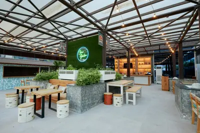 an outdoor patio with wooden tables and benches at Citymax Hotel Business Bay in Dubai