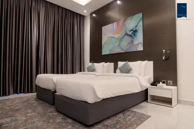 a bedroom with a large bed in a room at Samaya Hotel Apartment Dubai in Dubai