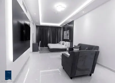 a living room with a couch and a chair at Samaya Hotel Apartment Dubai in Dubai