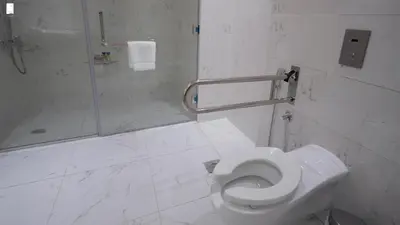 a white bathroom with a shower and a toilet at Samaya Hotel Apartment Dubai in Dubai