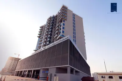a tall building in the middle of a city at Samaya Hotel Apartment Dubai in Dubai