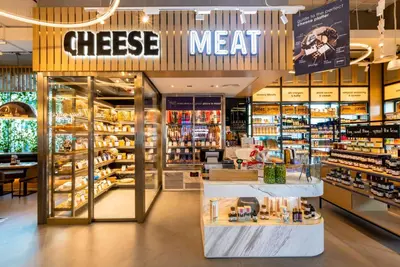 a cheese store with a cheese meat sign in a store at Radisson RED Dubai Silicon Oasis in Dubai