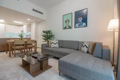 a living room with a couch and a table at Cozy 1BR Apart With Pool And Gym 10mins Away By drive to DXB Airport in Dubai