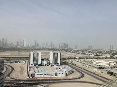 an aerial view of a city with tall buildings at Cozy 1BR Apart With Pool And Gym 10mins Away By drive to DXB Airport in Dubai