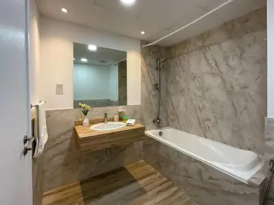 a bathroom with a sink and a tub and a mirror at HiGuests - Amazing Sea Views from this 2BR Apt in JBR in Dubai