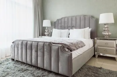 a bedroom with a large bed with two lamps and a rug at Nasma Luxury Stays - Pastel-Colored Apt With Jaw-Dropping Marina Views in Dubai