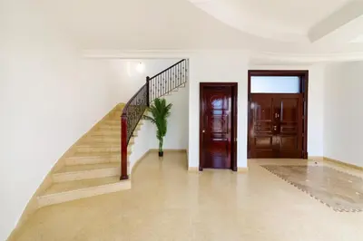 a hallway with a staircase and a door at Maison Privee - 5 Stars Villa with Private Pool or Beach on Palm Jumeirah in Dubai