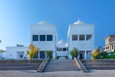 a white building with stairs in front of it at Maison Privee - 5 Stars Villa with Private Pool or Beach on Palm Jumeirah in Dubai