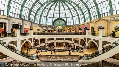 an overhead view of a shopping mall with a glass domed ceiling at Grand Cosmopolitan Hotel in Dubai