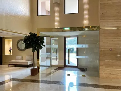 a lobby with a couch and a potted plant at Luxury Apartments at Balqis Residence in Dubai
