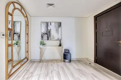 a hallway with a door and a mirror at Luxury Apartments at Balqis Residence in Dubai