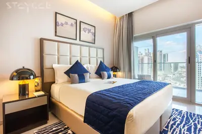 a bedroom with a large bed and a large window at Staycae Holiday Homes - Majestine in Dubai