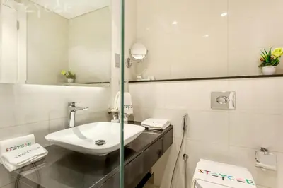 a white bathroom with a sink and a mirror at Staycae Holiday Homes - Majestine in Dubai