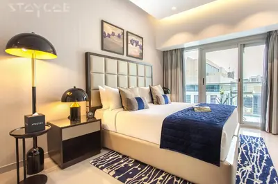a bedroom with a bed and a large window at Staycae Holiday Homes - Majestine in Dubai