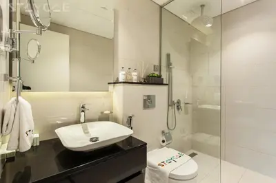 a bathroom with a toilet and a sink and a shower at Staycae Holiday Homes - Majestine in Dubai