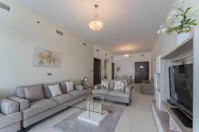 a living room with couches and a tv and a fireplace at Holiday Apartment in Palm Jumeirah with Beach Access in Dubai