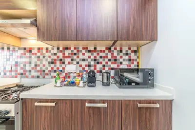 a kitchen with a counter top with a microwave at Holiday Apartment in Palm Jumeirah with Beach Access in Dubai