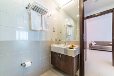 a bathroom with a sink and a mirror at Holiday Apartment in Palm Jumeirah with Beach Access in Dubai