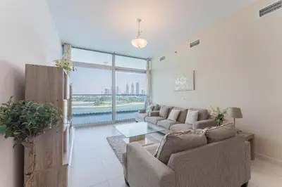 a living room with a couch and a table at Holiday Apartment in Palm Jumeirah with Beach Access in Dubai